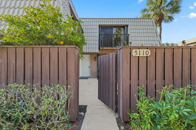 a view of a house with a garden and plants