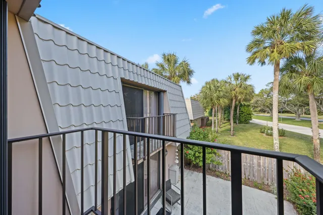 a view of a backyard with wooden fence