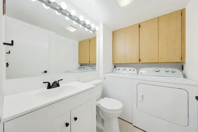 a bathroom with a sink a toilet and vanity