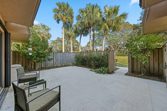 a backyard of a house with table and chairs