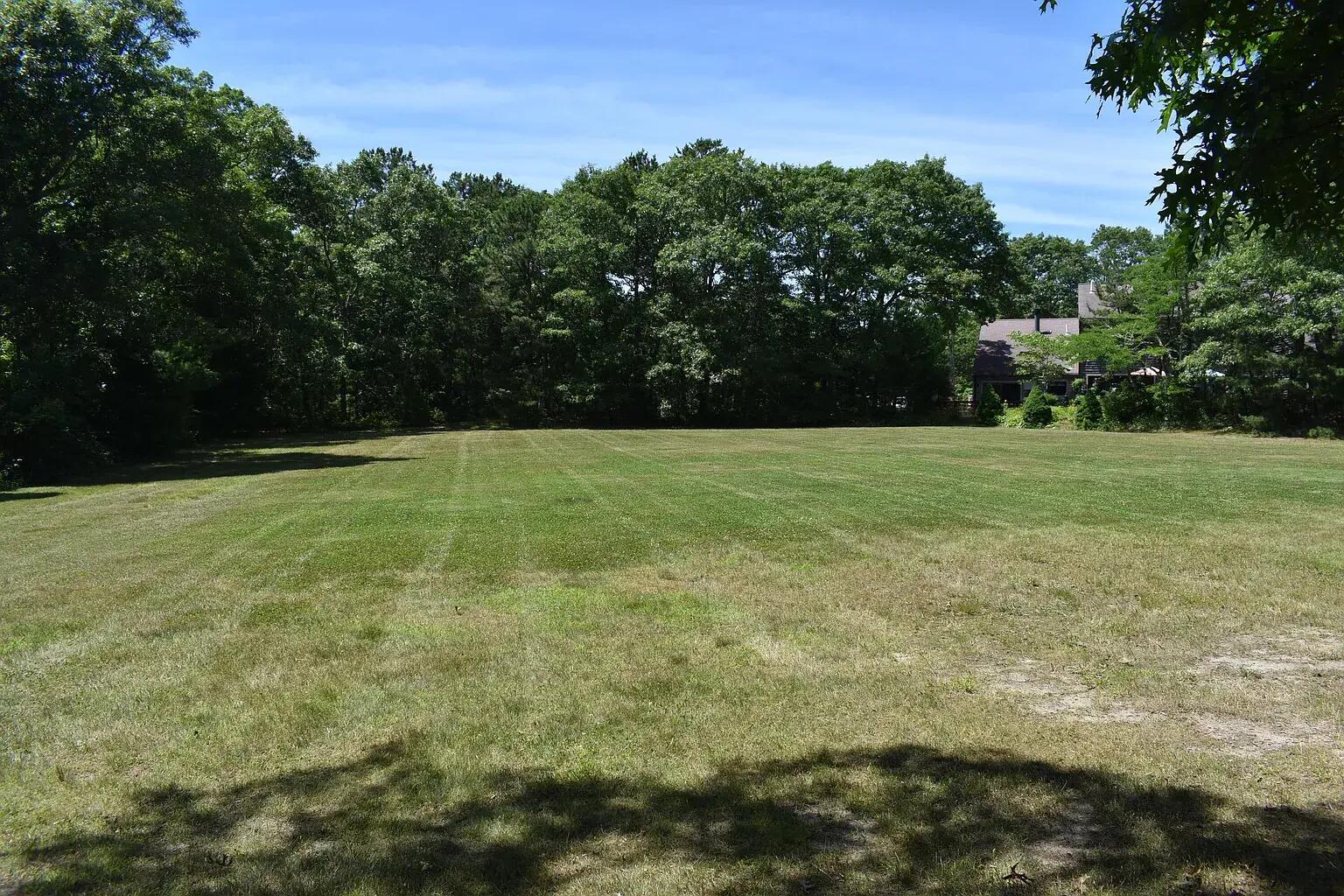 77 Round House Road Buzzards Bay, MA 02532 - Photo 33 of 36 a view of a field with trees in the background