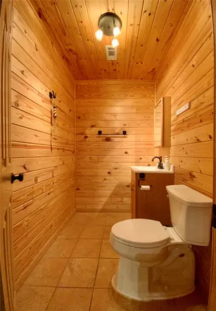 a bathroom with a toilet and a shower