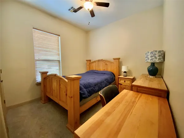 a bedroom with two beds and lamps