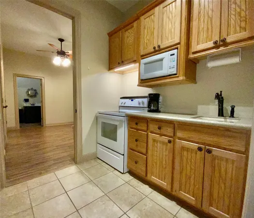 a kitchen with cabinets and appliances