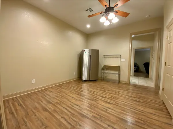 wooden floor in an empty room and a bathroom
