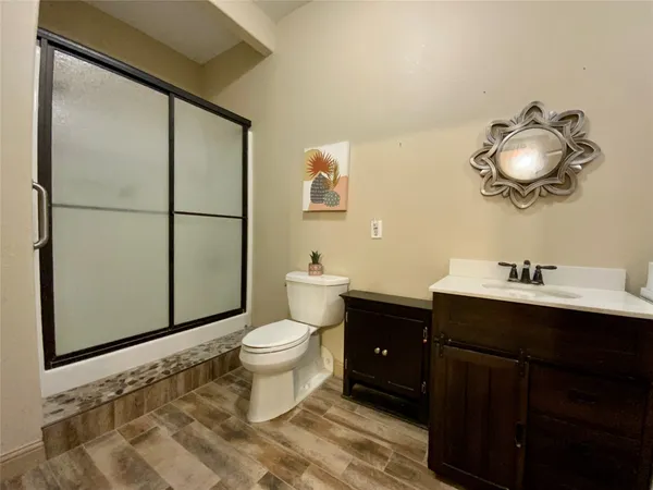 a bathroom with a sink toilet and mirror