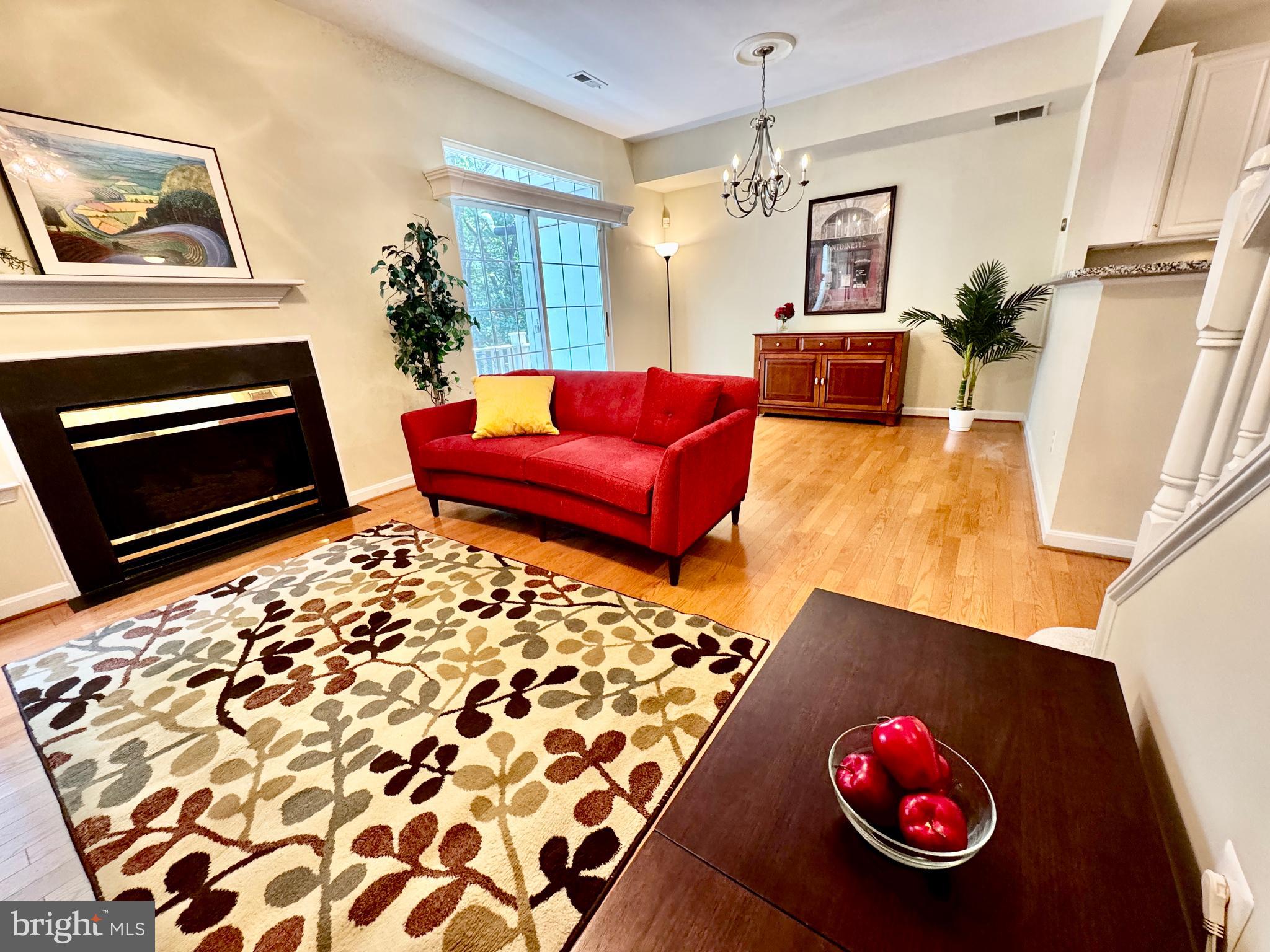 1307 Windleaf Drive, Unit 139N Reston, VA 20194 - Photo 1 of 38 a living room with furniture and a fireplace