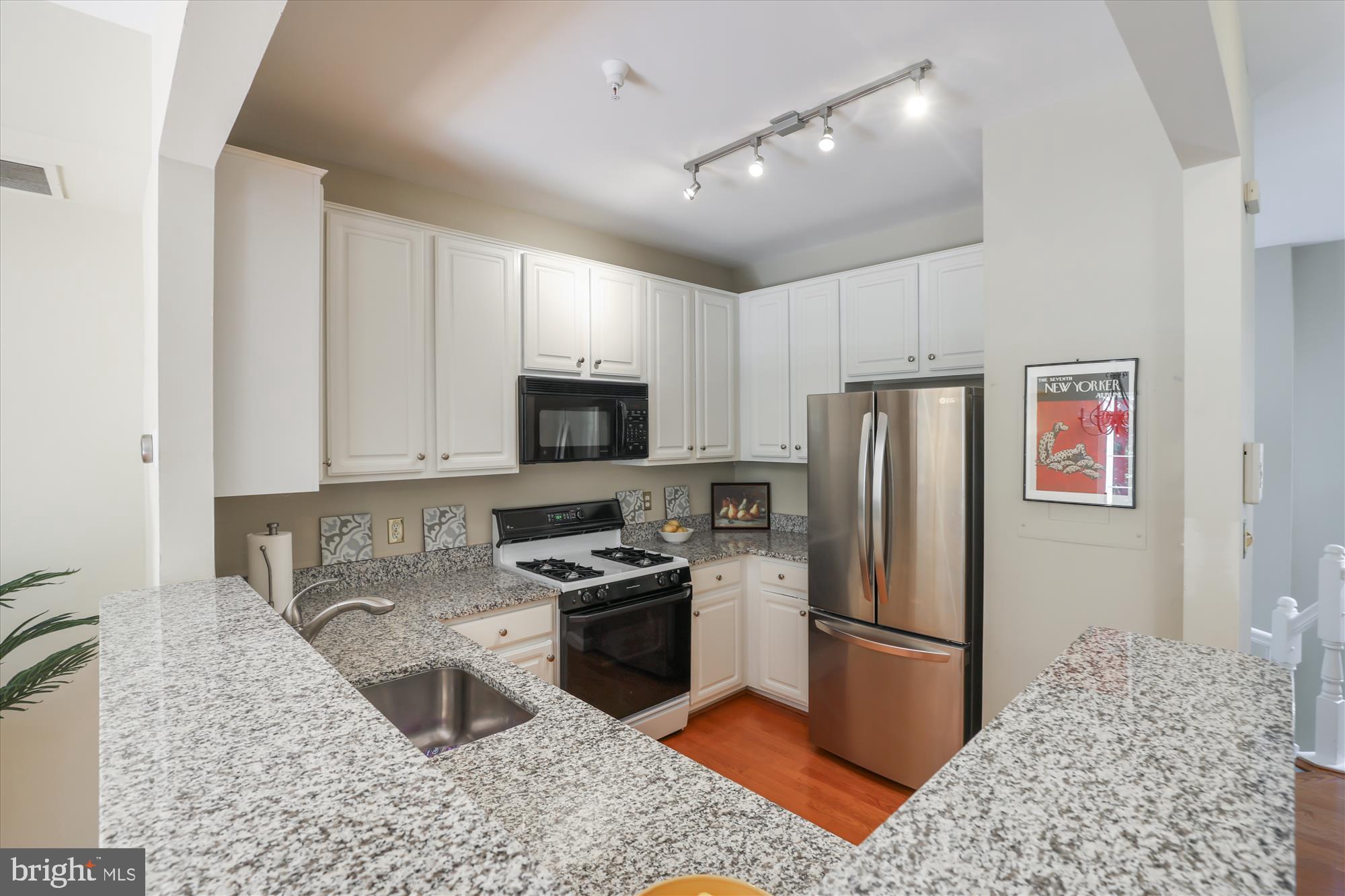 1307 Windleaf Drive, Unit 139N Reston, VA 20194 - Photo 16 of 38 a kitchen with stainless steel appliances granite countertop a refrigerator stove and sink