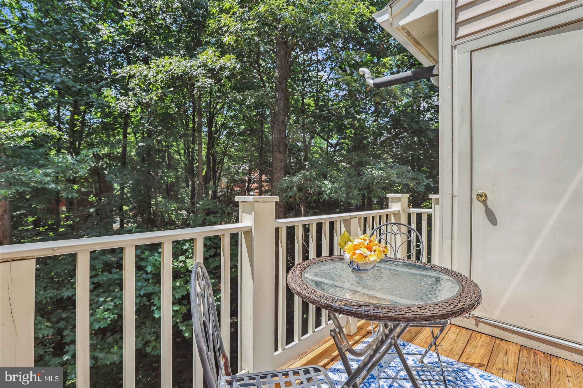 1307 Windleaf Drive, Unit 139N Reston, VA 20194 - Photo 21 of 38 a balcony with a table and chairs with wooden floor and fence