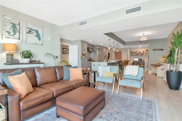 a living room with furniture and kitchen view