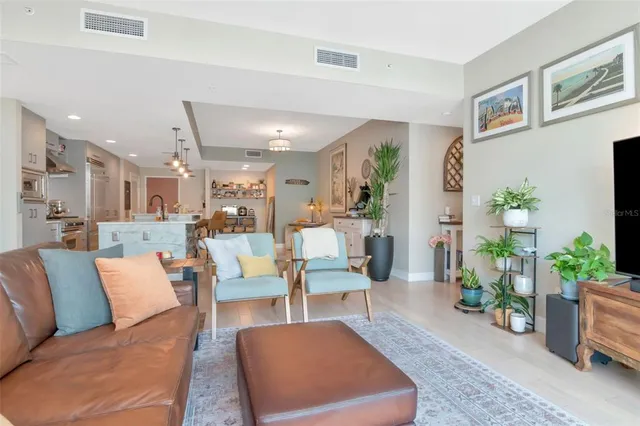 a living room with furniture potted plant and a window