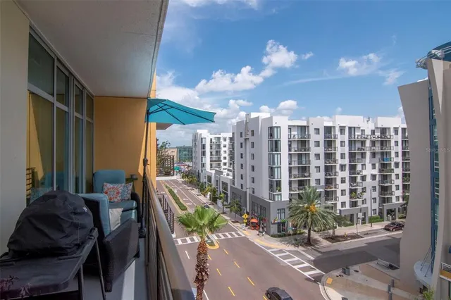 a balcony with furniture and a potted plant