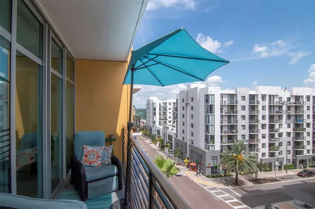 a view of a balcony with an outdoor seating