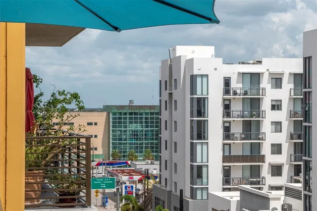 a view of a patio with a dining table and chairs with wooden floor