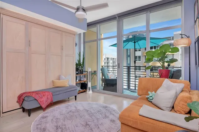 a living room with furniture and a floor to ceiling window