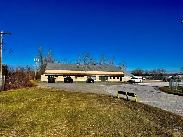 a view of a building with swimming pool and sitting area