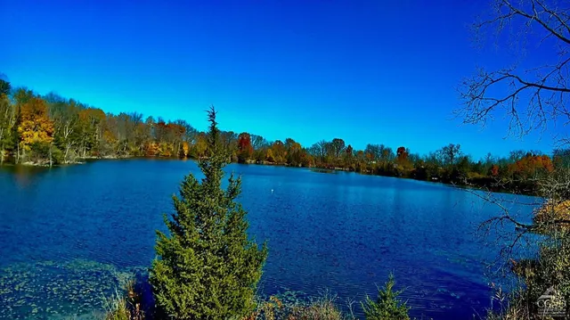 a view of a lake with a house in background