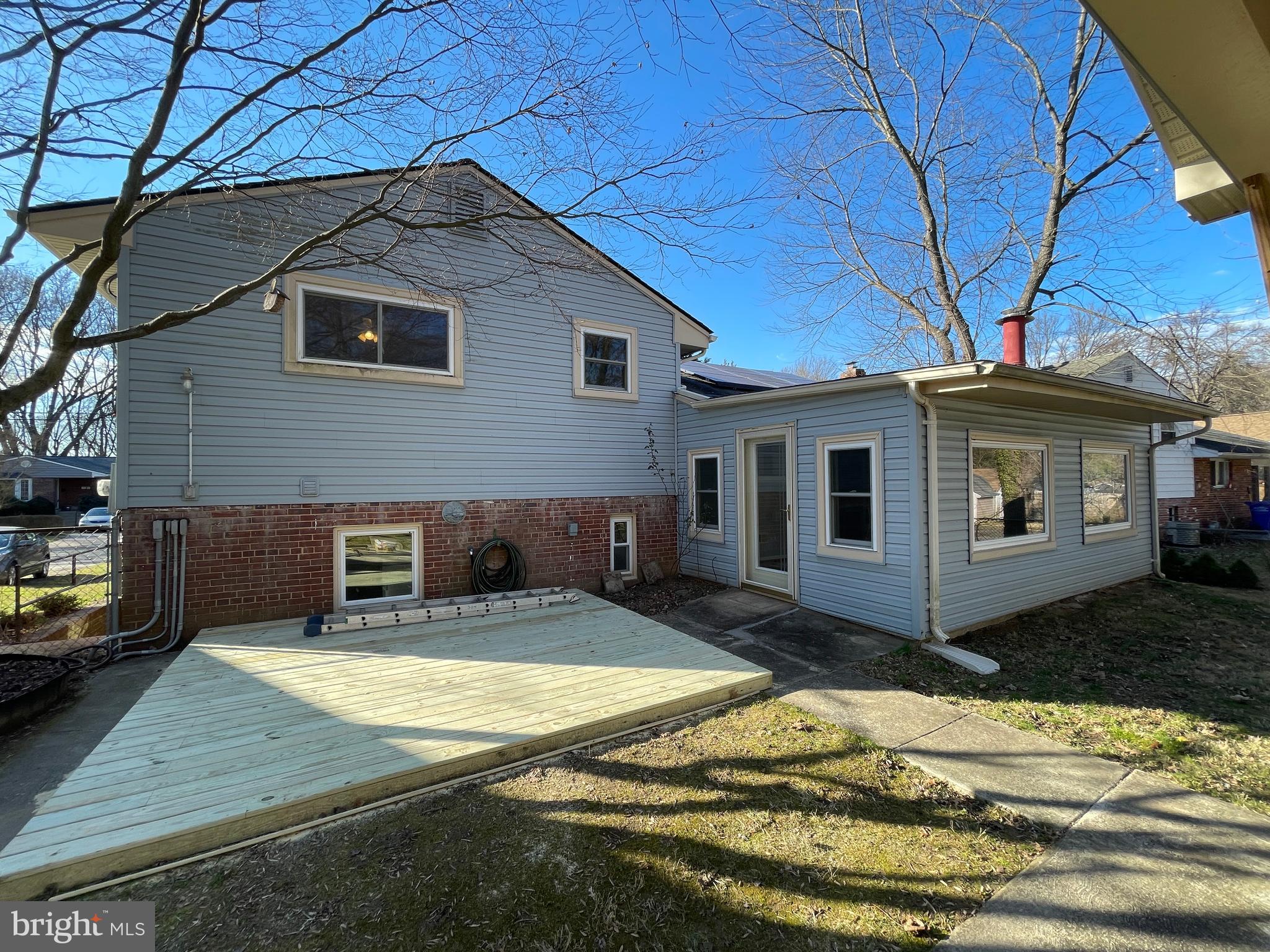 12705 Littleton Street Silver Spring, MD 20906 - Photo 27 of 33 Rear of home with deck, showing sunroom addition
