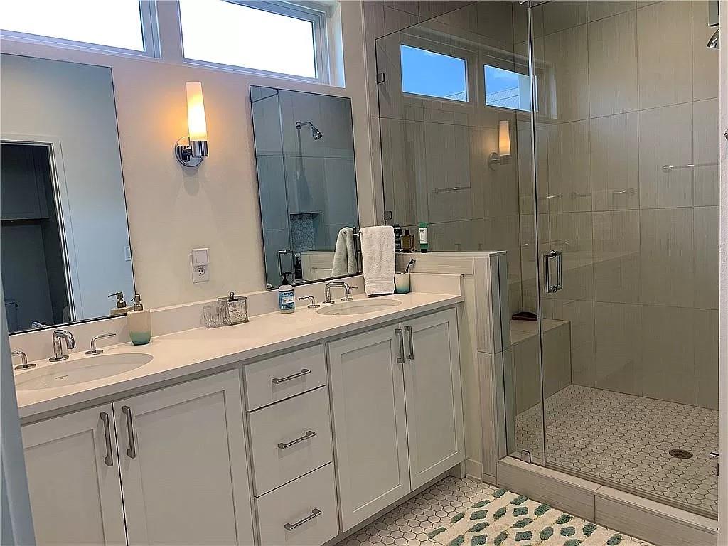 2519 Sutherland Street Austin, TX 78746 - Photo 9 of 14 a bathroom with a shower sink and mirror