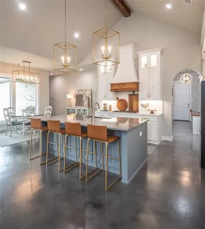 a large kitchen with a table and chairs