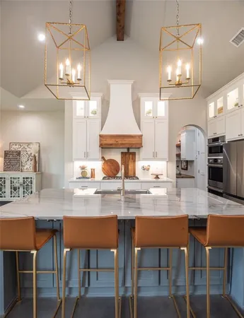 a kitchen with a dining table a sink and chairs