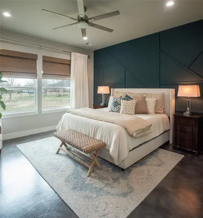 a bedroom with a bed and a large window