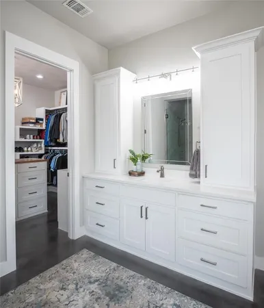 a spacious bathroom with a sink and a mirror