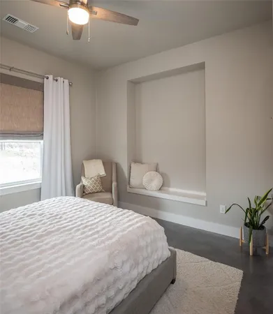 a bedroom with a bed and window