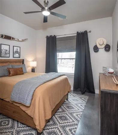 a bedroom with a large bed and a window