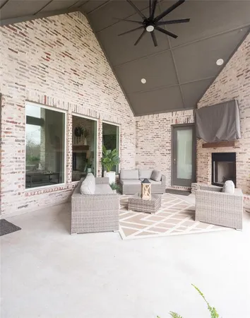 a view of a patio with a fireplace tv and outdoor seating