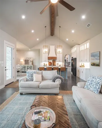 a living room with furniture and kitchen view