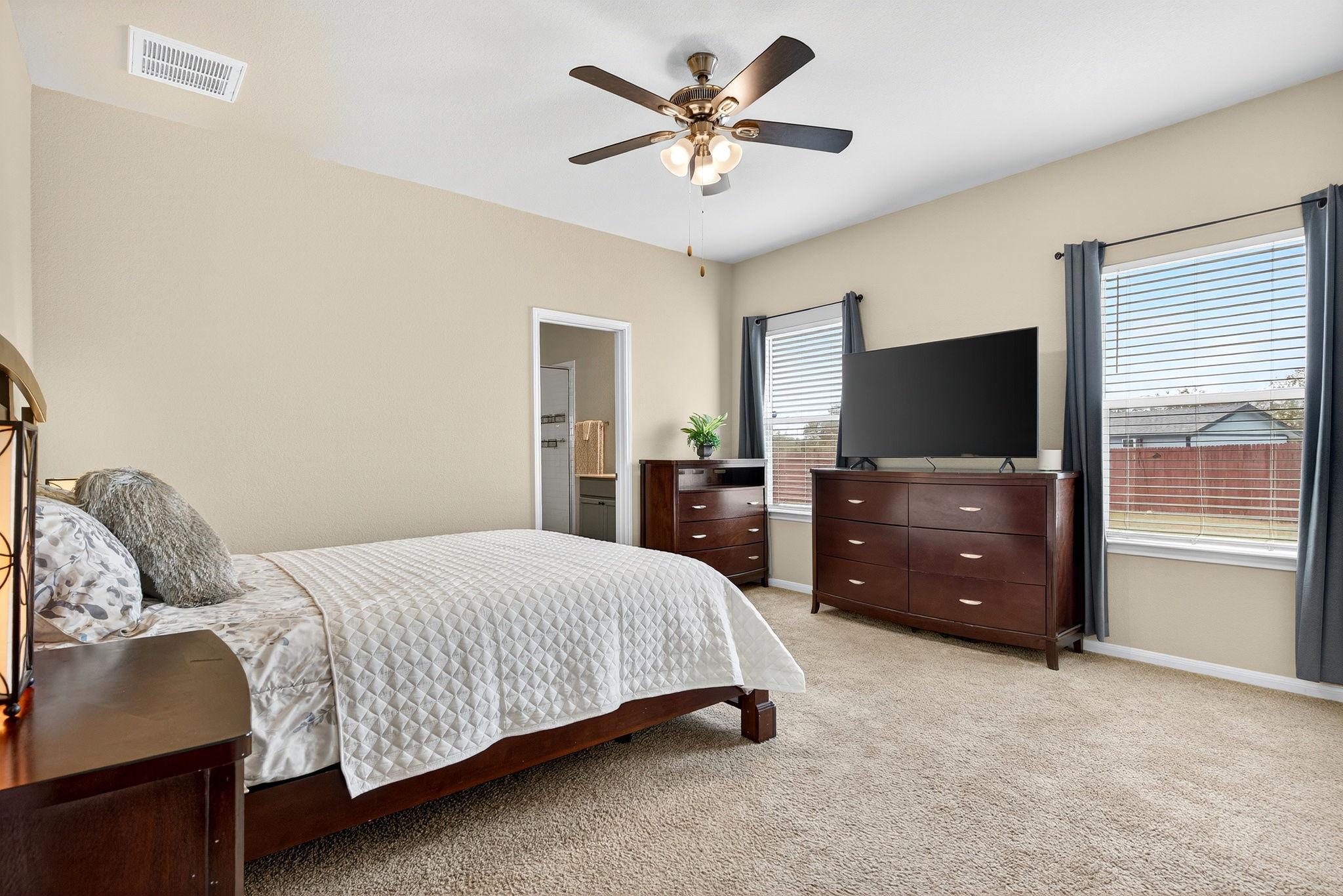 131 Coleto Creek Loop Kyle, TX 78640 - Photo 11 of 30 Oversized owner’s suite tucked privately at the rear of the home with ensuite bath and walk-in closet access.