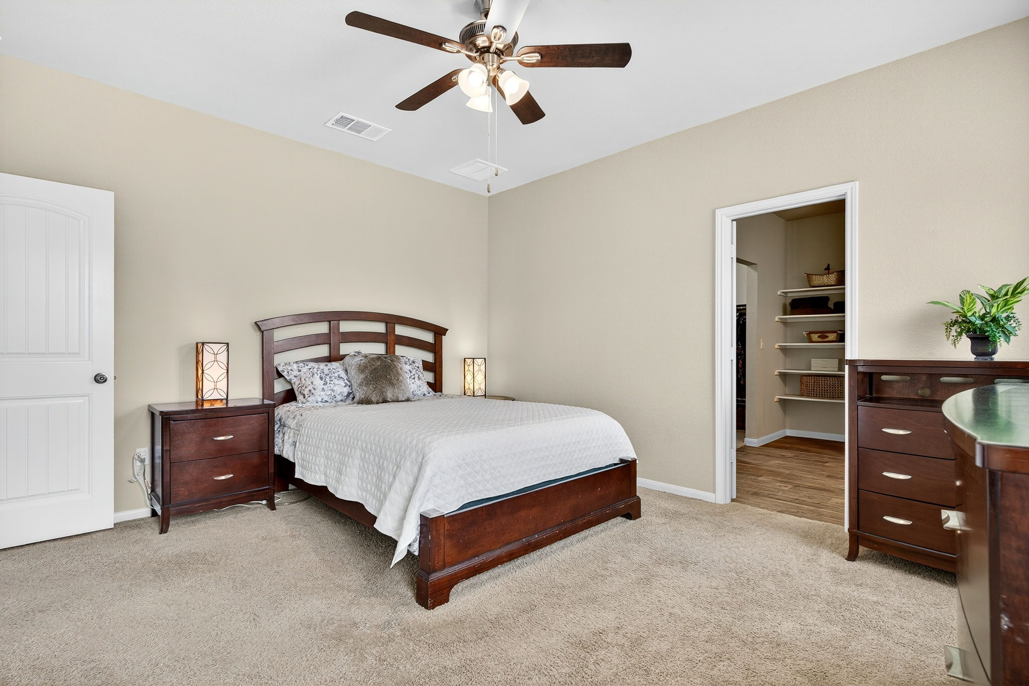 131 Coleto Creek Loop Kyle, TX 78640 - Photo 13 of 30 Bedroom featuring light carpet, ceiling fan, and a spacious closet