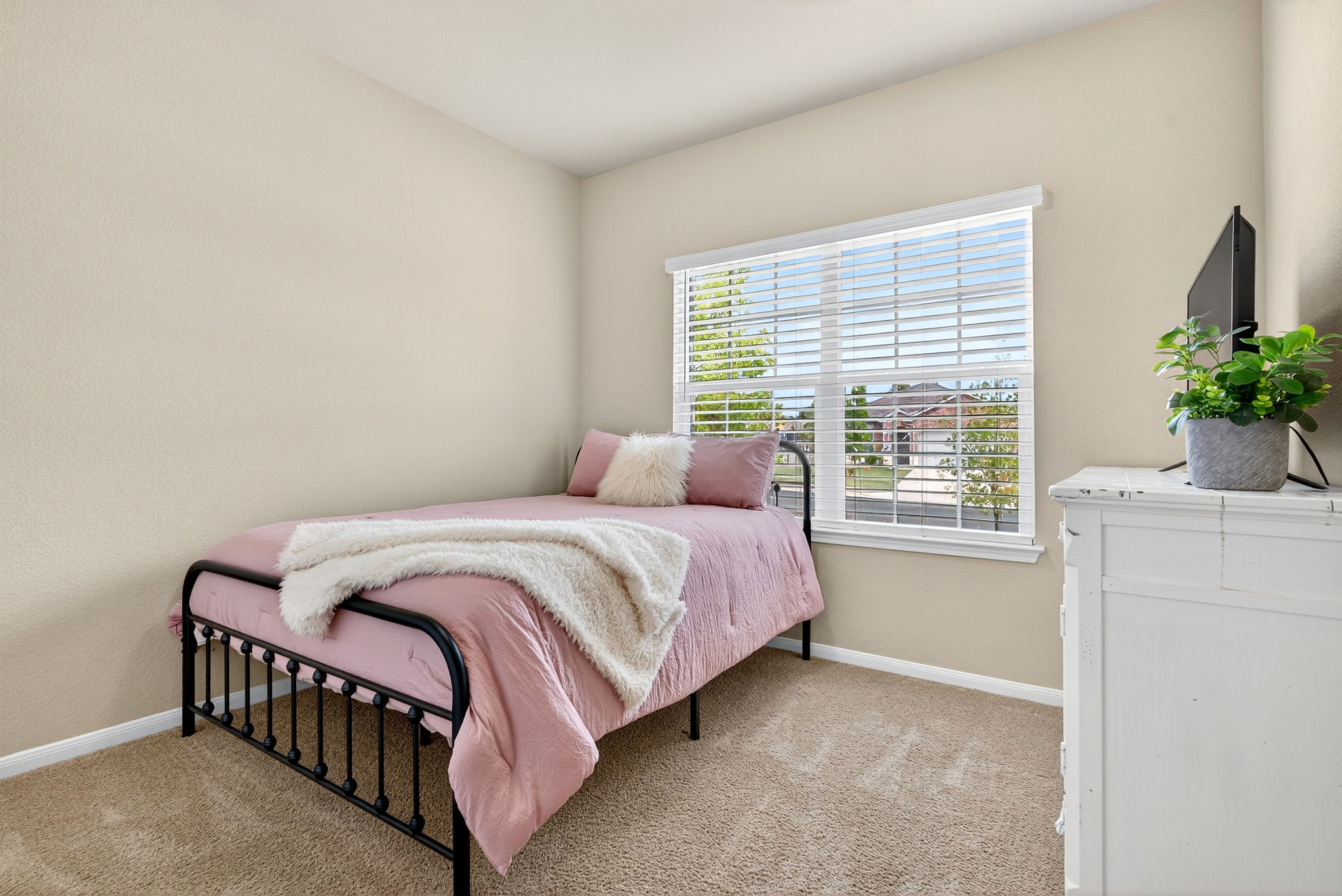 131 Coleto Creek Loop Kyle, TX 78640 - Photo 17 of 30 Front-facing bedroom with oversized window and charming natural light — great for a nursery or creative space.