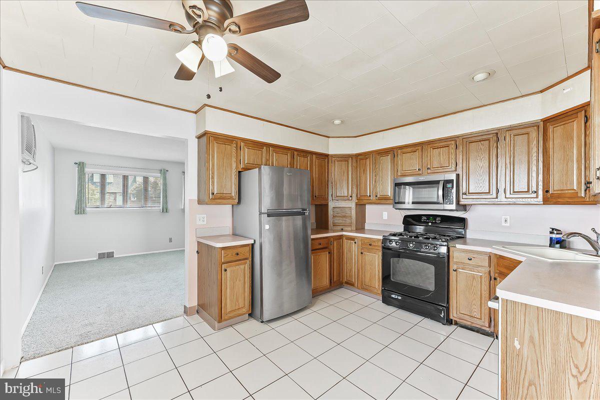 1003 Dale Road Secane, PA 19018 - Photo 6 of 29 a kitchen with refrigerator cabinets and window