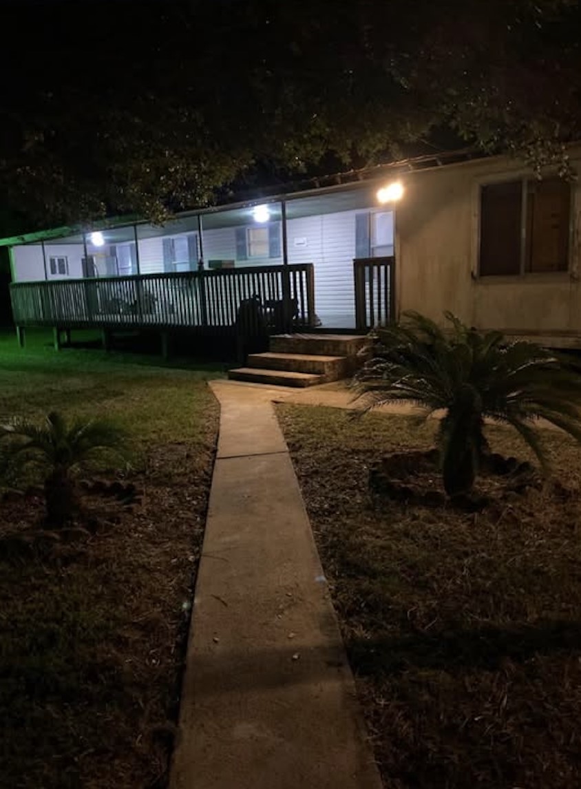 2130 Hayes Road Winnie, TX 77665 - Photo 13 of 13 a view of a backyard with table and chairs with wooden fence