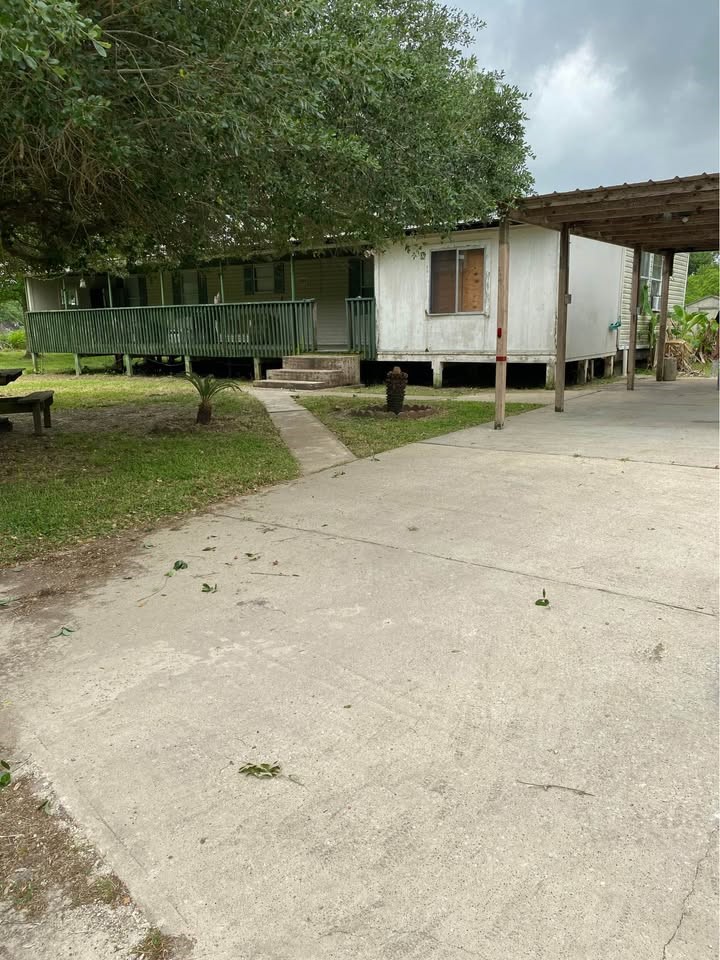 2130 Hayes Road Winnie, TX 77665 - Photo 2 of 13 a backyard of a house with barbeque oven table and chairs