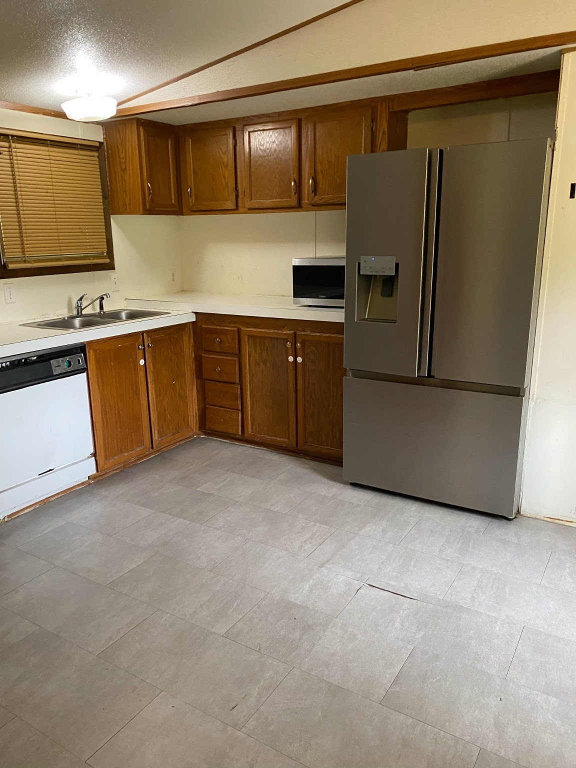 2130 Hayes Road Winnie, TX 77665 - Photo 7 of 13 a kitchen with granite countertop a refrigerator and a stove