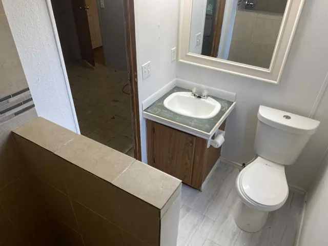 a bathroom with a sink toilet and shower