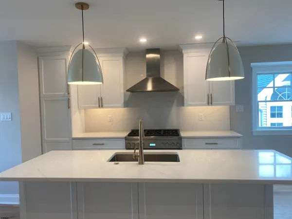 a stove top oven sitting inside of a kitchen