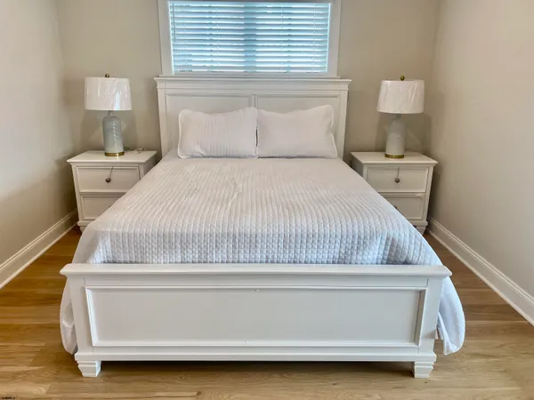 a bedroom with a bed and a night stand