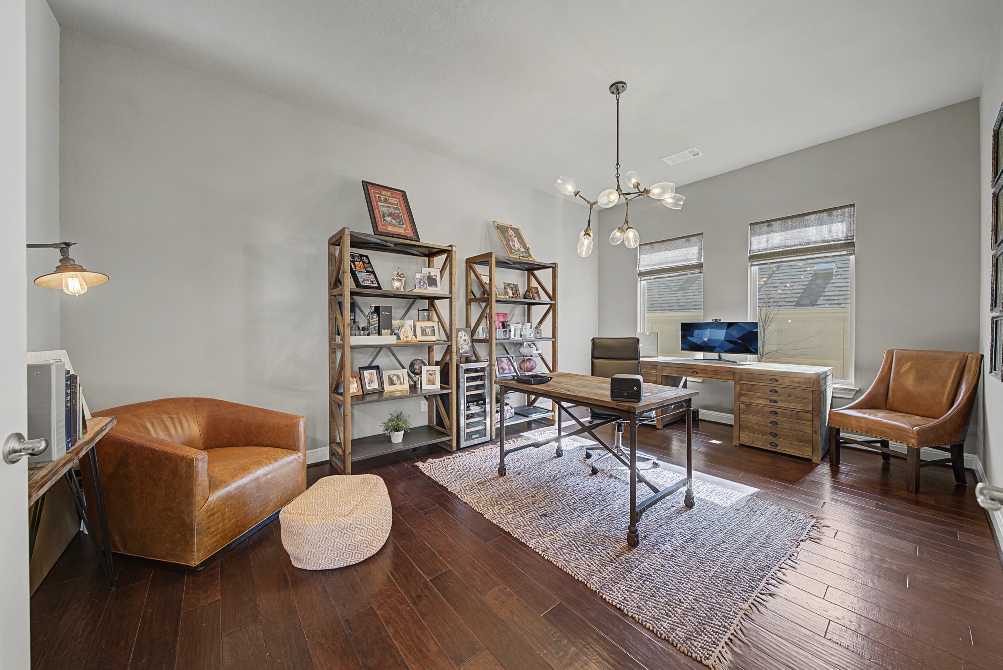 16024 La Rosa Drive Bee Cave, TX 78738 - Photo 21 of 39 Massive private study with double glass French doors, two windows and a Sputnik chandelier.