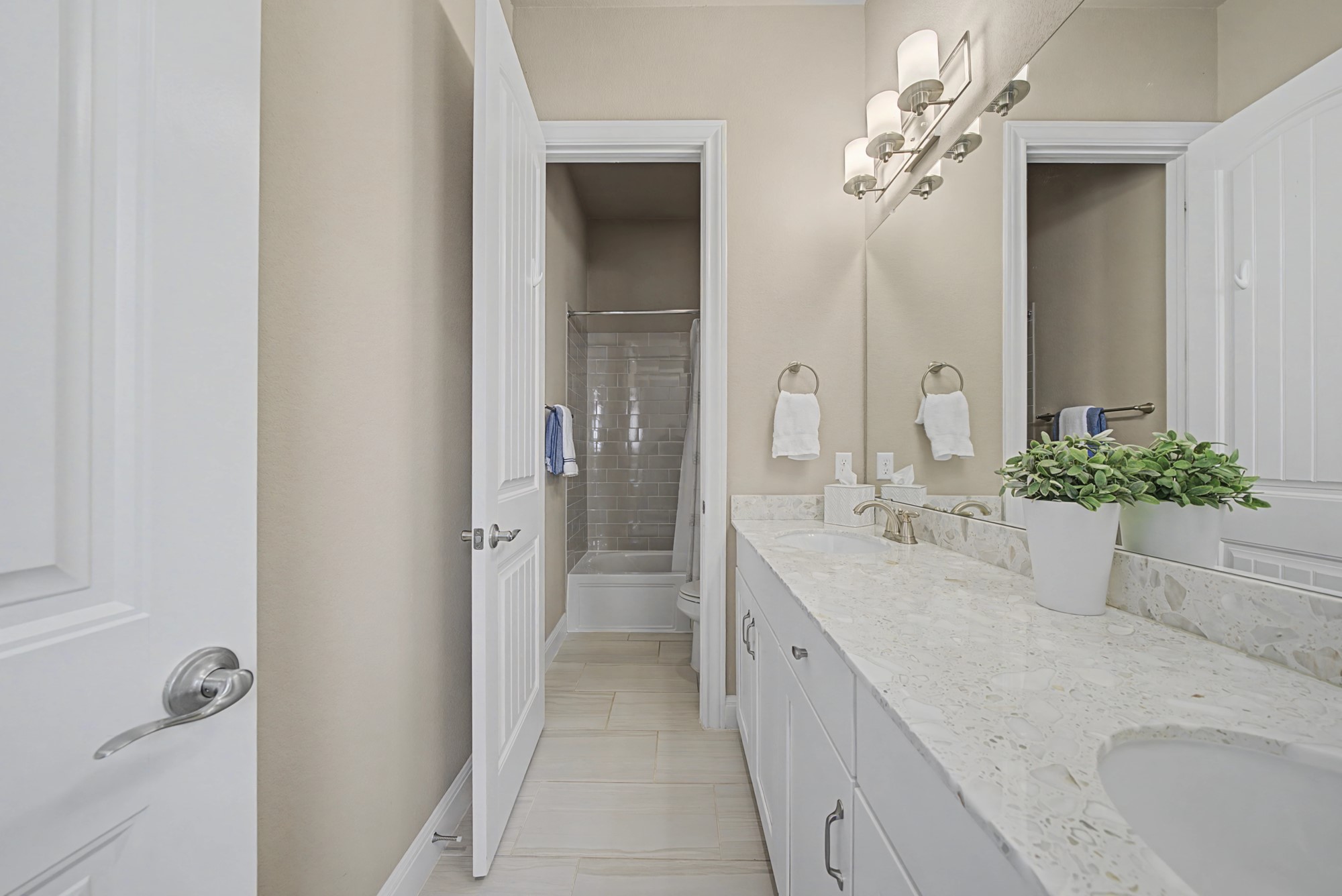 16024 La Rosa Drive Bee Cave, TX 78738 - Photo 28 of 39 A shared bath with dual vanities, upgraded tile floors and shower.