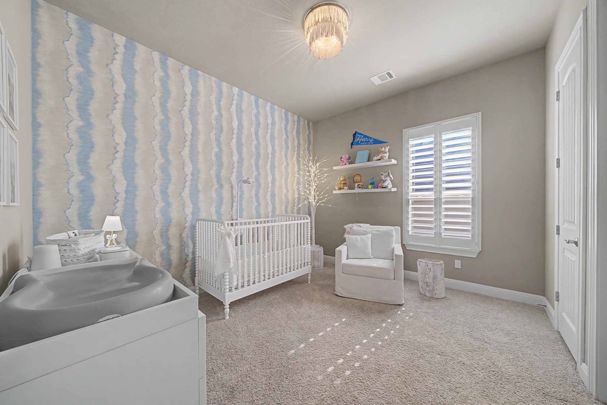 16024 La Rosa Drive Bee Cave, TX 78738 - Photo 30 of 39 Bedroom #4 with gorgeous wallpaper, chandelier and walk-in closet - plus an ensuite.