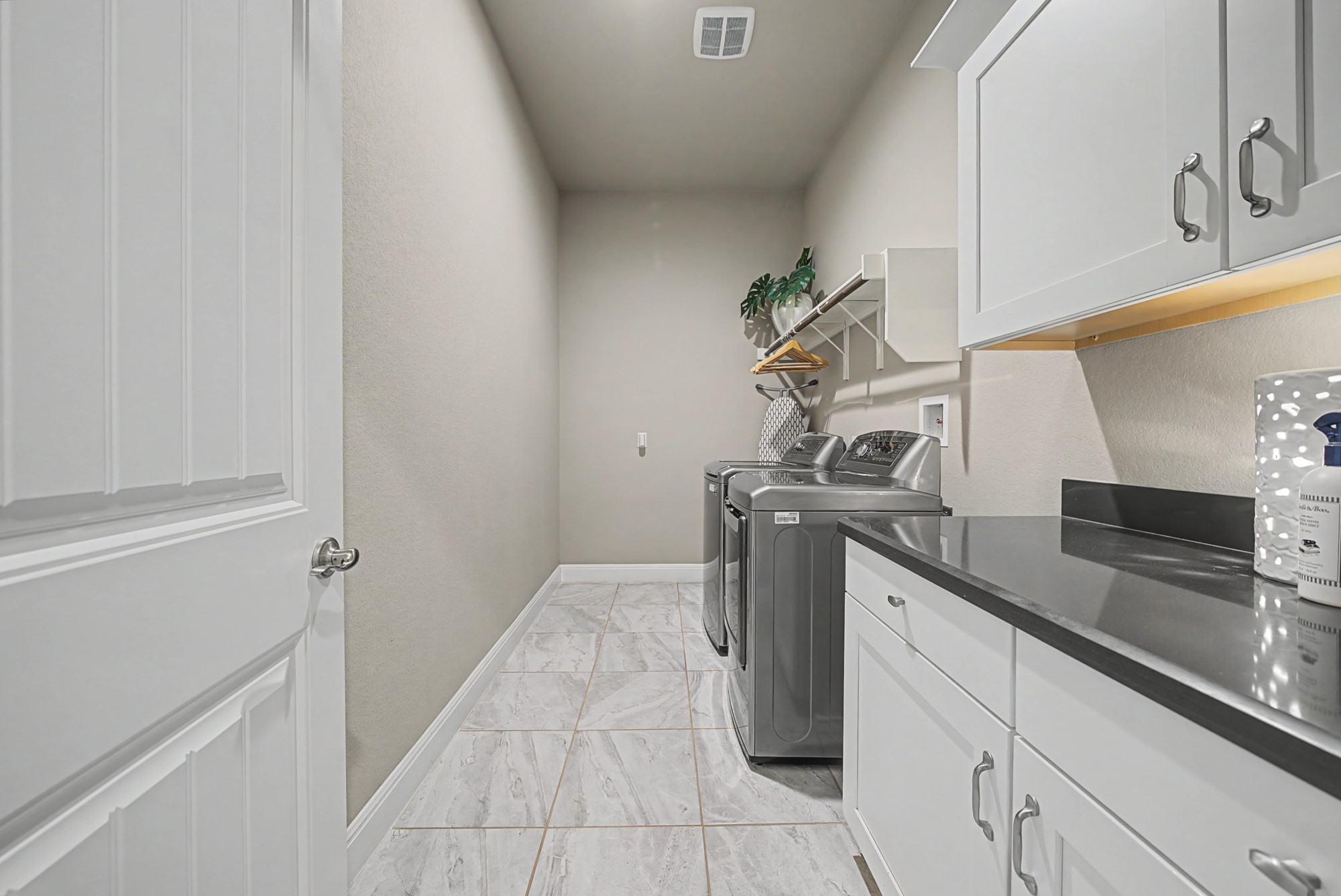 16024 La Rosa Drive Bee Cave, TX 78738 - Photo 33 of 39 Amazing laundry room with granite counter, upper and lower cabinets and space for a second fridge.