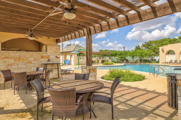 a patio with water view fountain with swimming pool