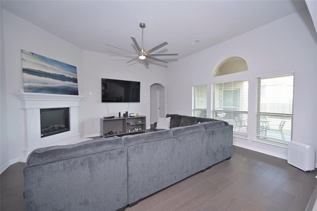 1802 Ranch View Drive Cedar Hill, TX 75104 - Photo 13 of 40 a living room with furniture a flat screen tv and a fireplace