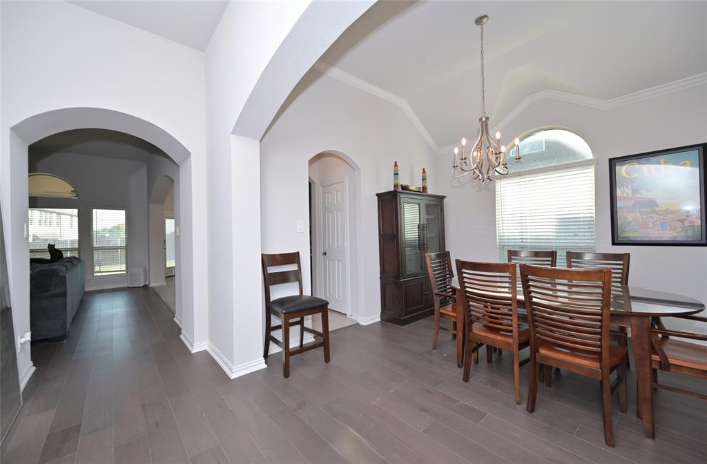 1802 Ranch View Drive Cedar Hill, TX 75104 - Photo 16 of 40 a view of a livingroom with furniture a chandelier and wooden floor
