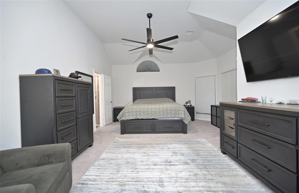 1802 Ranch View Drive Cedar Hill, TX 75104 - Photo 20 of 40 a bedroom with a bed and a flat screen tv