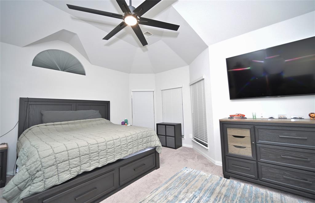 1802 Ranch View Drive Cedar Hill, TX 75104 - Photo 22 of 40 a bedroom with a bed and flat screen tv